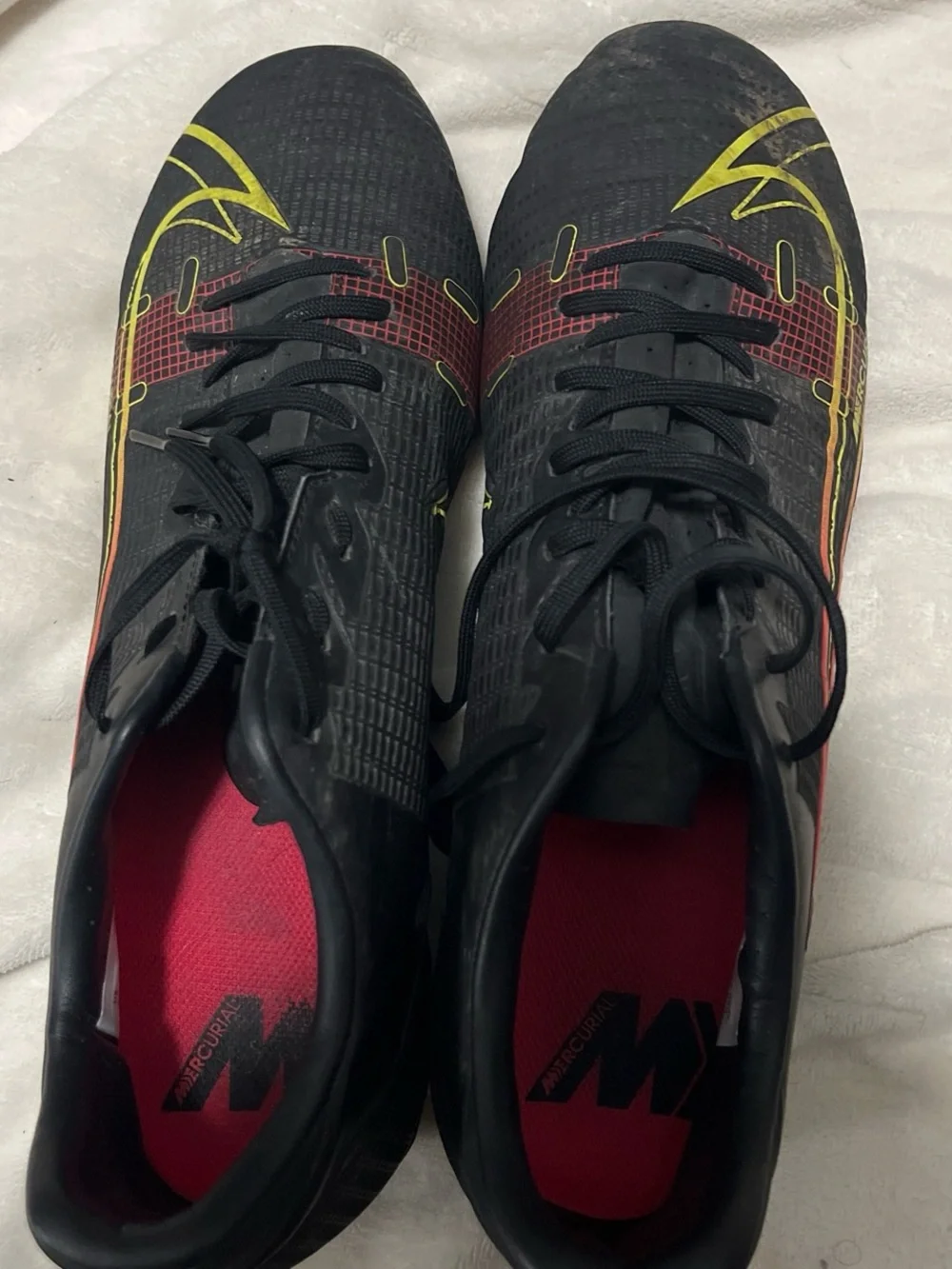 Nike Men's Black Soccer Cleats with Yellow and Red Accents